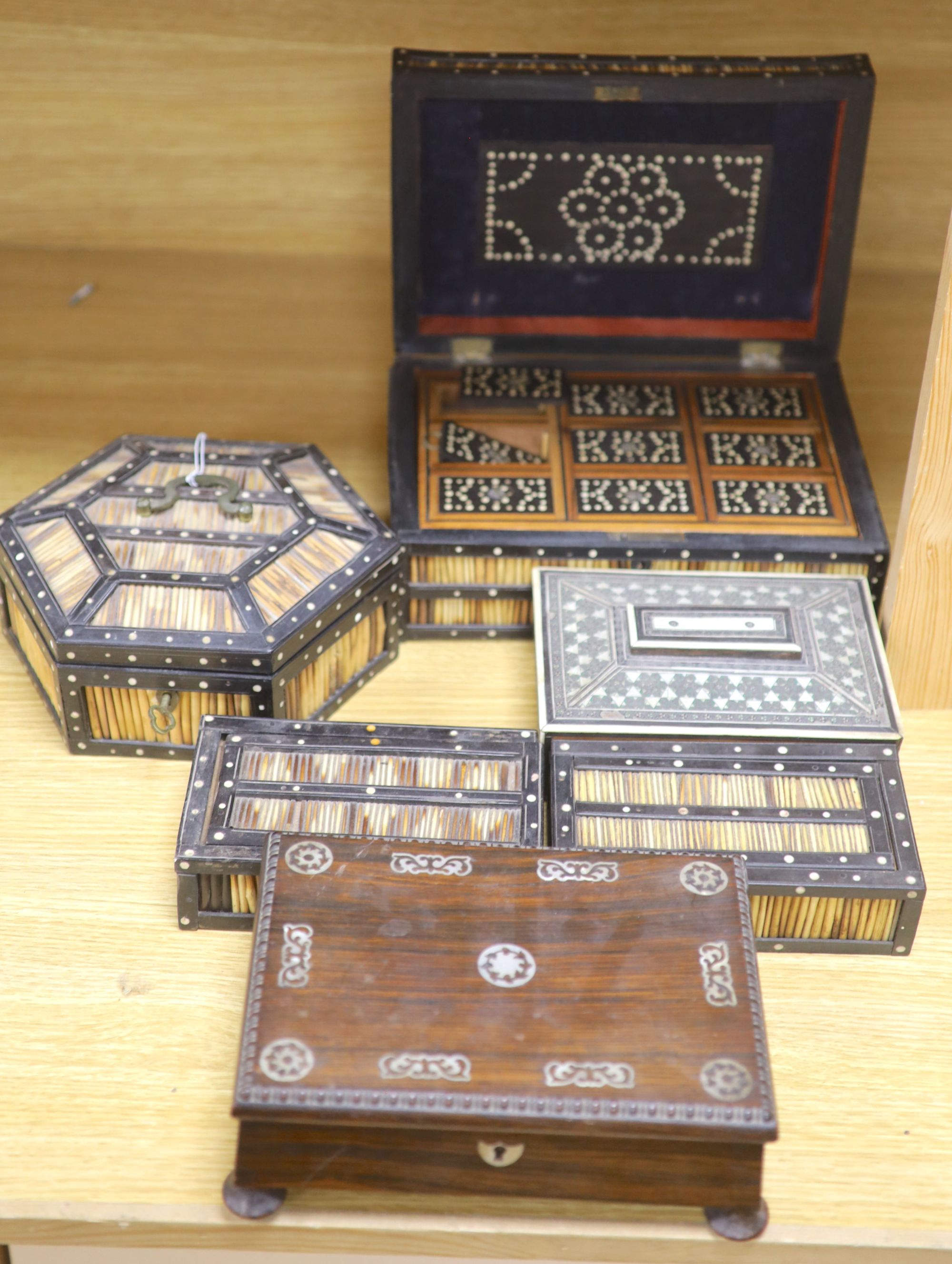 Four Ceylonese quillwork boxes, early 20th century, largest 28 x 19 x 10cm, an Indian inlaid box a Victorian rosewood sewing box